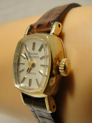 LADIES BULOVA ACCUTRON,  10 K GOLD FILL CASE WITH CROWN 2