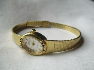 Sarah Coventry Supreme Wristwatch Gold Tone Floral Band Oval Shaped Face