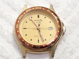 Vintage Bulova Dual Time Date Watch Red Bezel Luminous Hands Gold Tone Men 